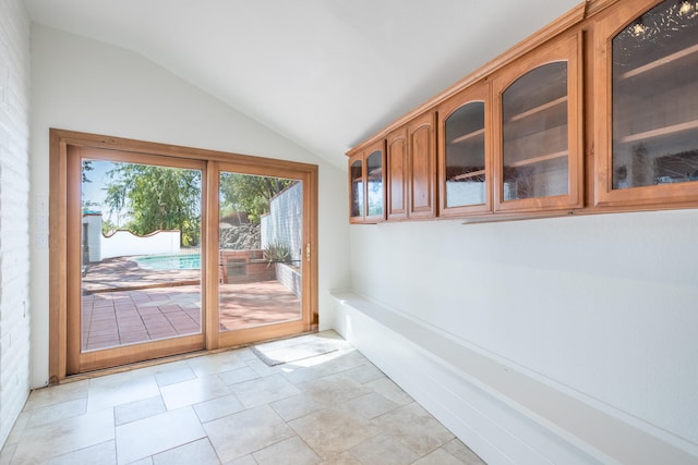 doorway featuring vaulted ceiling