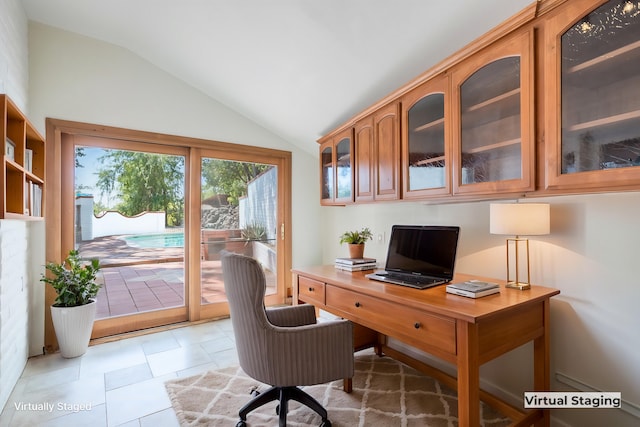 office with tile patterned flooring and lofted ceiling