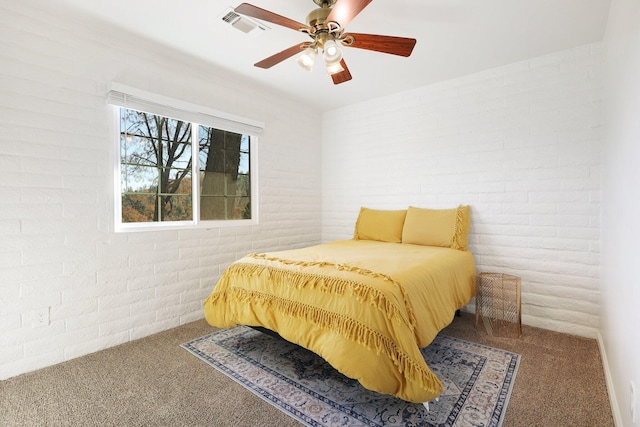 bedroom featuring carpet flooring, ceiling fan, and brick wall