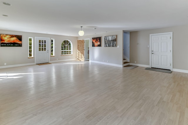 unfurnished living room with light hardwood / wood-style floors