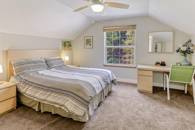 carpeted bedroom with ceiling fan and vaulted ceiling