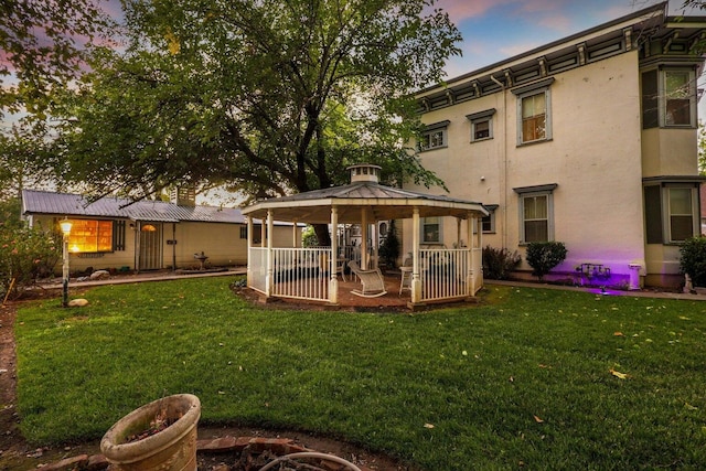 exterior space with a gazebo and an outdoor fire pit