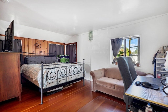 bedroom featuring hardwood / wood-style floors and vaulted ceiling