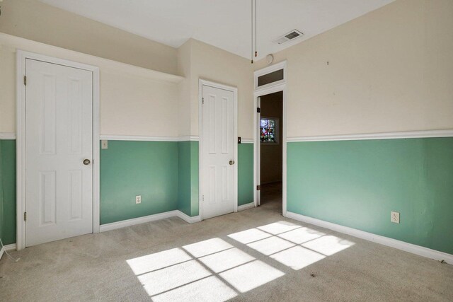 unfurnished bedroom featuring light carpet