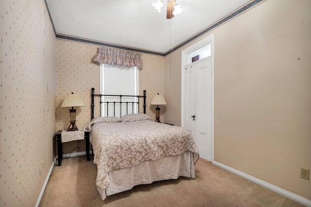 bedroom featuring a closet, ornamental molding, carpet, and ceiling fan