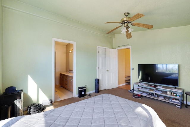 carpeted bedroom featuring ceiling fan and ensuite bathroom