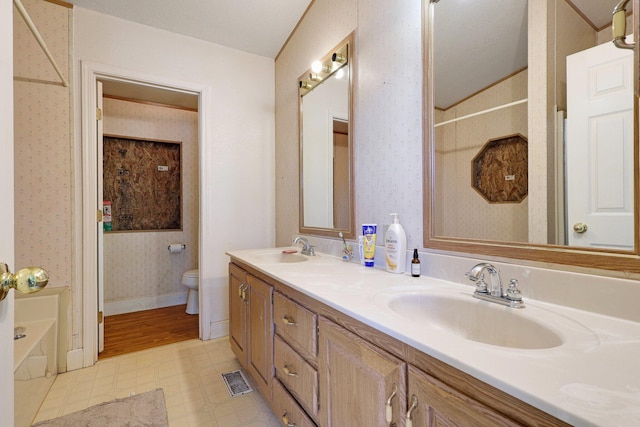 bathroom featuring a tub, a textured ceiling, toilet, lofted ceiling, and vanity