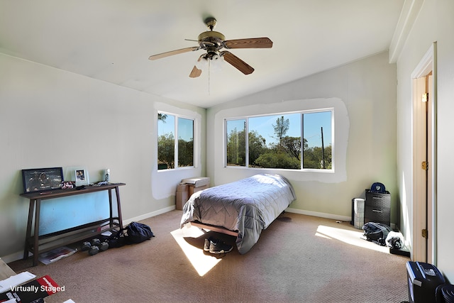 bedroom with ceiling fan, lofted ceiling, multiple windows, and light colored carpet