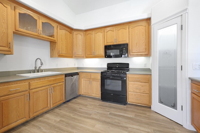 kitchen featuring sink, light hardwood / wood-style flooring, and black appliances