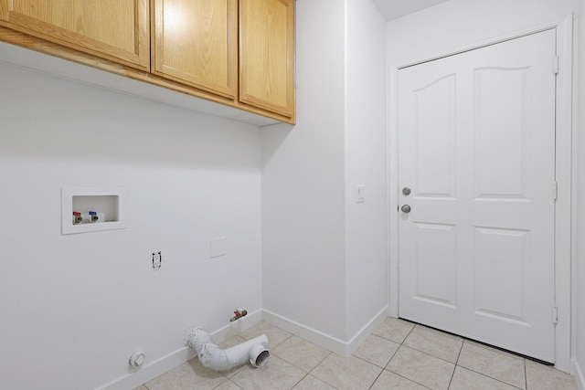 laundry room featuring cabinets, gas dryer hookup, hookup for a washing machine, and light tile patterned floors