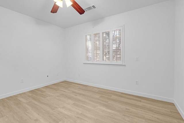 empty room with ceiling fan and light hardwood / wood-style floors