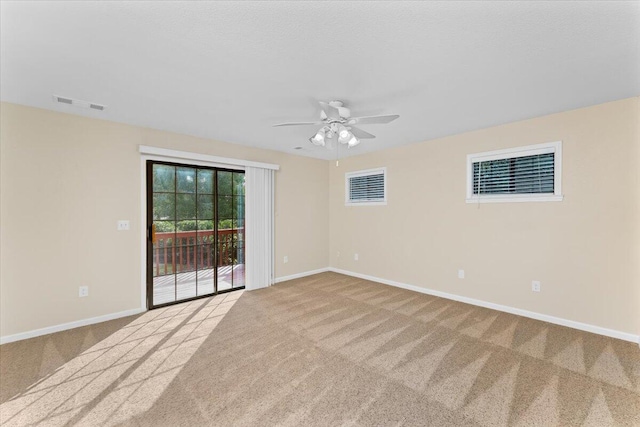 spare room with light carpet and ceiling fan