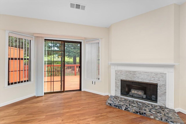 unfurnished living room with light hardwood / wood-style flooring and plenty of natural light