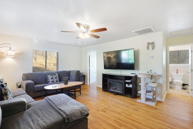 living room featuring light hardwood / wood-style floors and ceiling fan