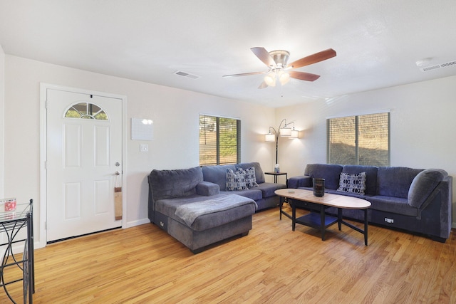 living room featuring light hardwood / wood-style flooring and ceiling fan