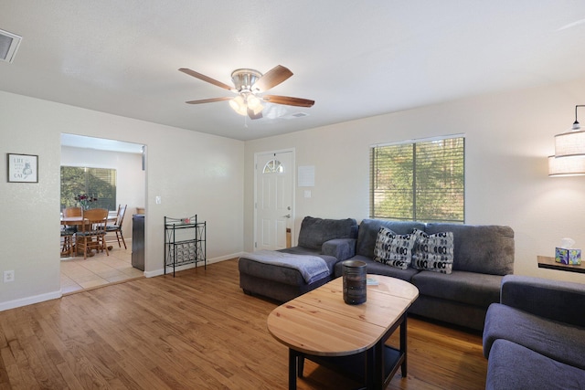 living room featuring ceiling fan and hardwood / wood-style flooring