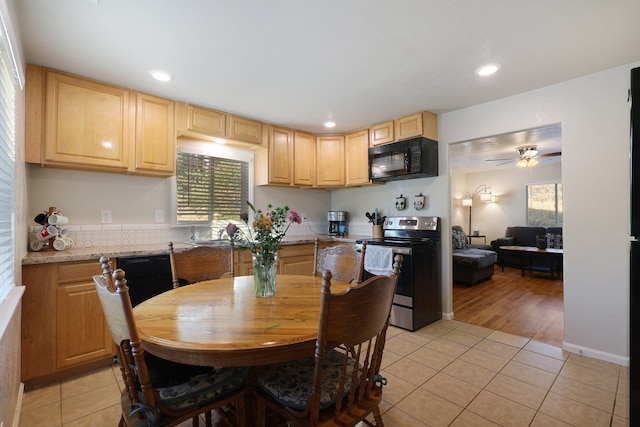 kitchen with light stone countertops, light wood-type flooring, ceiling fan, stainless steel electric range oven, and light brown cabinets