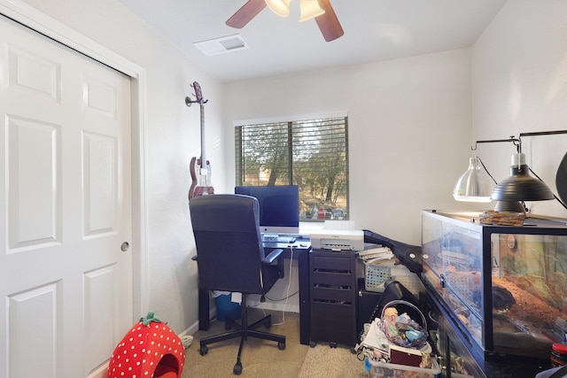 home office featuring light carpet and ceiling fan