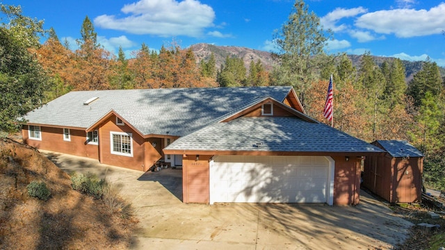 view of front facade with a mountain view and a garage