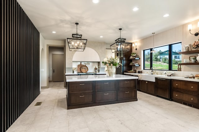 kitchen featuring open shelves, a chandelier, light countertops, and recessed lighting