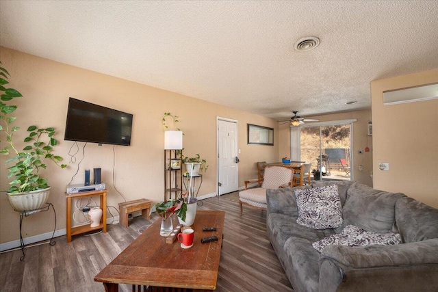 living room with dark hardwood / wood-style floors, a textured ceiling, and ceiling fan