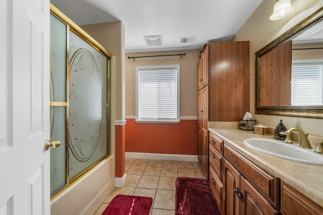 bathroom featuring tile patterned flooring, vanity, and enclosed tub / shower combo