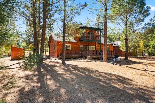 back of property featuring a balcony