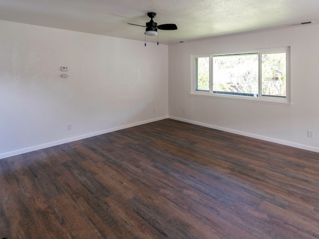 empty room featuring dark wood-type flooring and ceiling fan