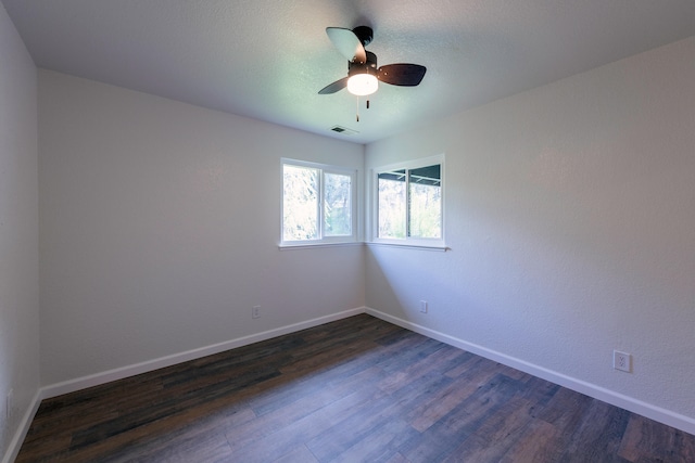 empty room with dark hardwood / wood-style floors and ceiling fan