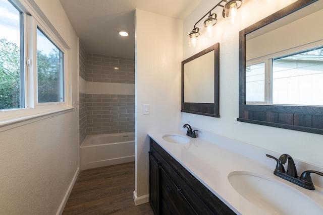 bathroom featuring vanity, wood-type flooring, and a tub