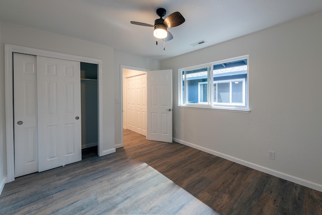 unfurnished bedroom with dark hardwood / wood-style floors and ceiling fan