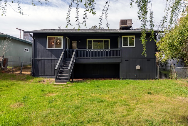 view of front of home with a front yard and central AC