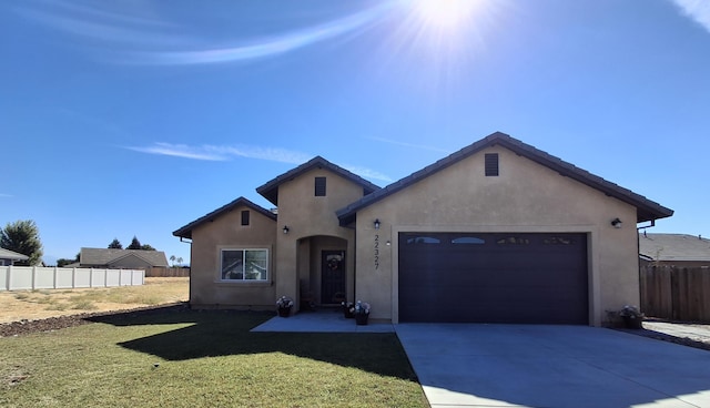 view of front facade featuring a garage and a front lawn