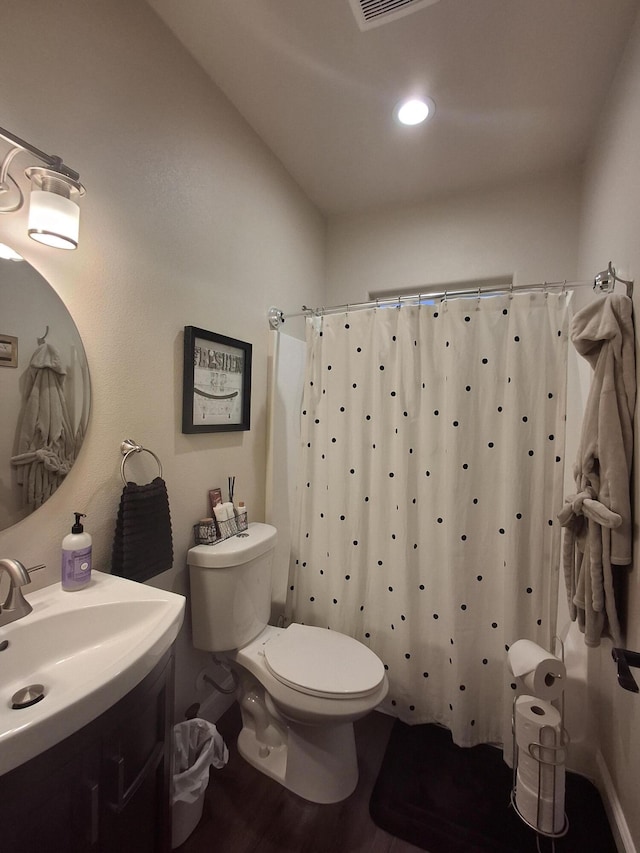 bathroom featuring a shower with shower curtain, vanity, hardwood / wood-style flooring, and toilet