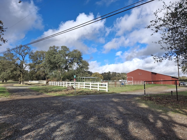 view of yard with a rural view and an outdoor structure