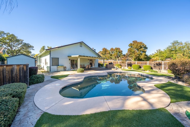 view of swimming pool with a fenced backyard, a fenced in pool, and a patio