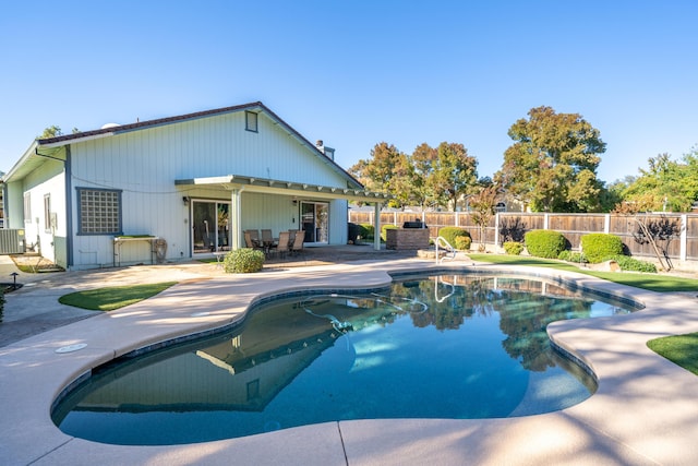 view of swimming pool featuring a patio area, a fenced backyard, cooling unit, and a fenced in pool