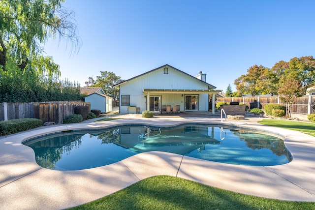 view of swimming pool featuring a fenced in pool, a fenced backyard, and a patio