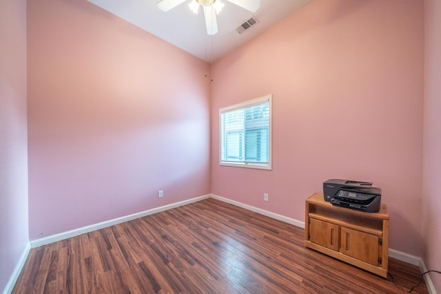 empty room with baseboards, visible vents, and wood finished floors