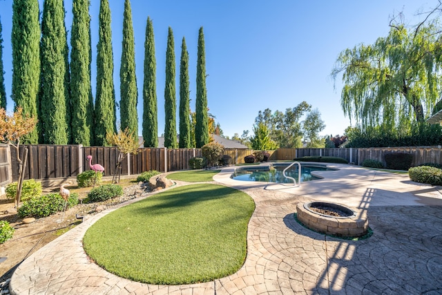 exterior space featuring an outdoor fire pit, a fenced backyard, a fenced in pool, and a patio