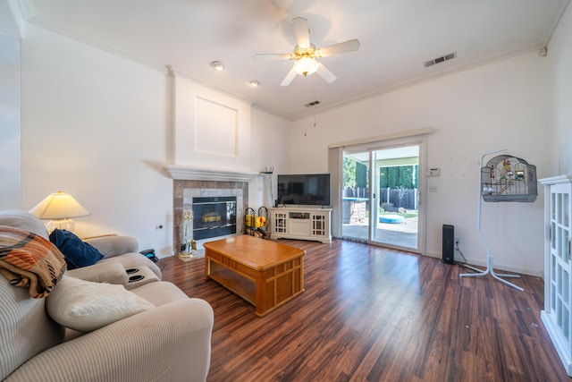 living area featuring ornamental molding, wood finished floors, and visible vents