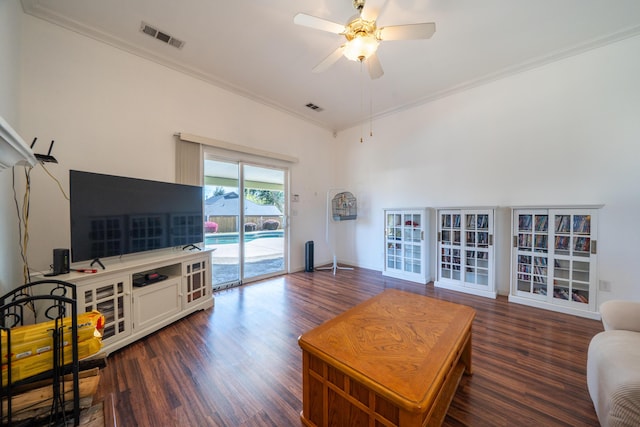 living room featuring ornamental molding, wood finished floors, visible vents, and a ceiling fan