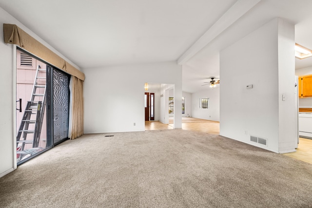 carpeted empty room featuring vaulted ceiling with beams and ceiling fan