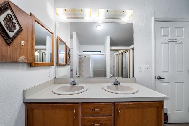 bathroom with vanity and a shower with shower door