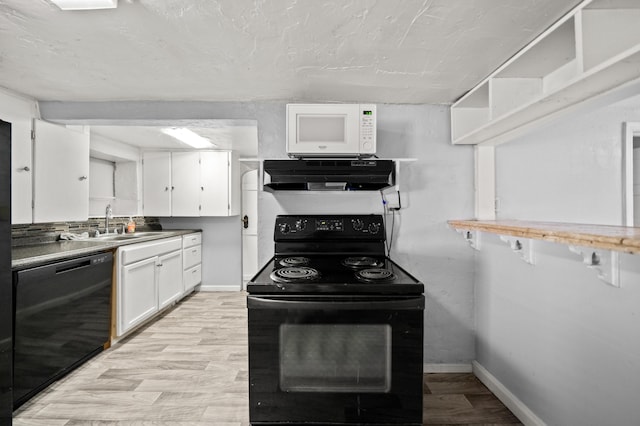 kitchen with white cabinetry, sink, black appliances, and light wood-type flooring