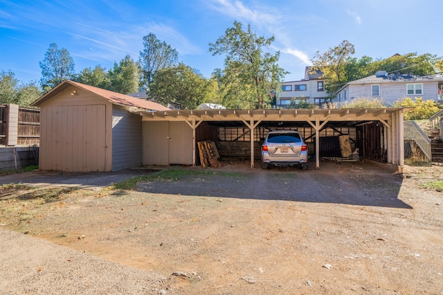 view of front of property with a shed and a carport