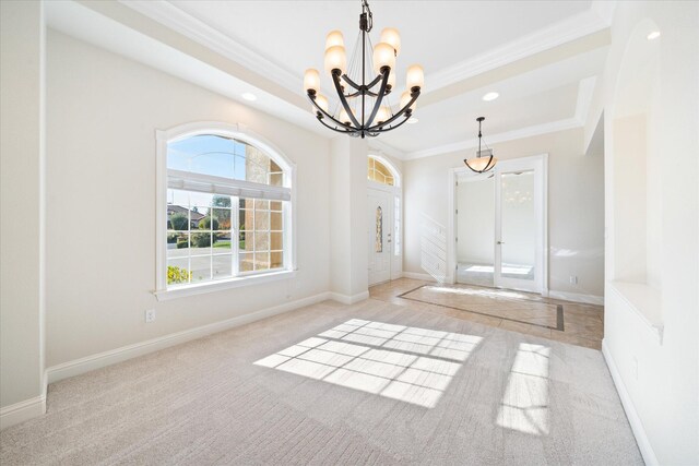 empty room featuring light carpet, a chandelier, and crown molding