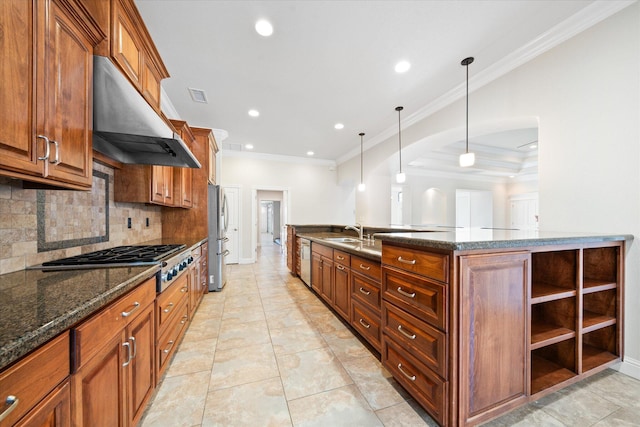 kitchen featuring decorative backsplash, sink, exhaust hood, pendant lighting, and appliances with stainless steel finishes