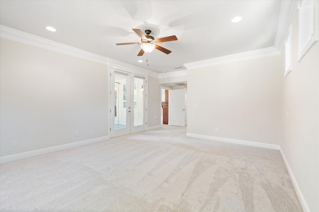 carpeted spare room featuring ceiling fan, french doors, and crown molding