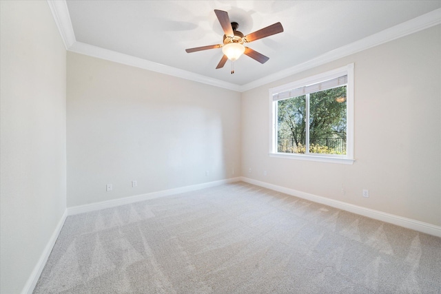 carpeted empty room with ornamental molding and ceiling fan